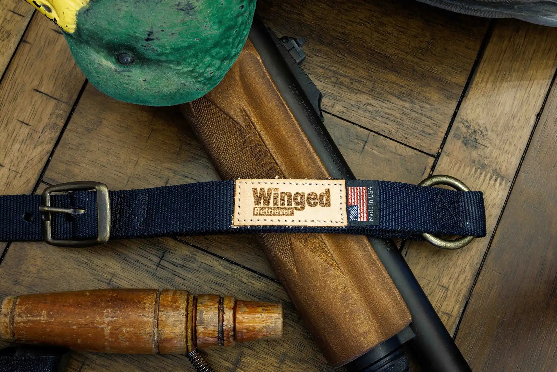 Patternmaster Wendy's Point Nylon Collar in navy with Winged Retriever patch on wooden surface.